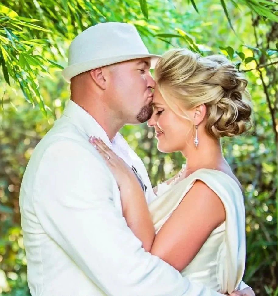 Bride and groom kissing under the trees at a Sonoma County wedding