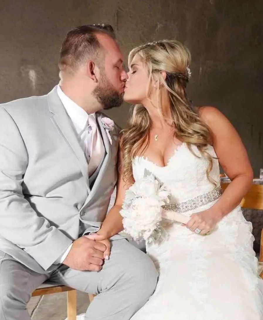 Bride and groom seated and kissing at their Sonoma County wedding