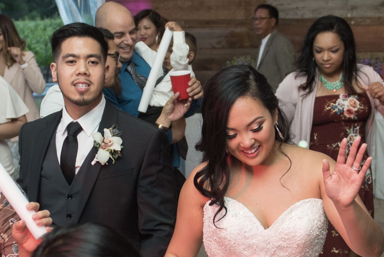 Bride and groom sharing their first dance in front of guests at their wedding reception